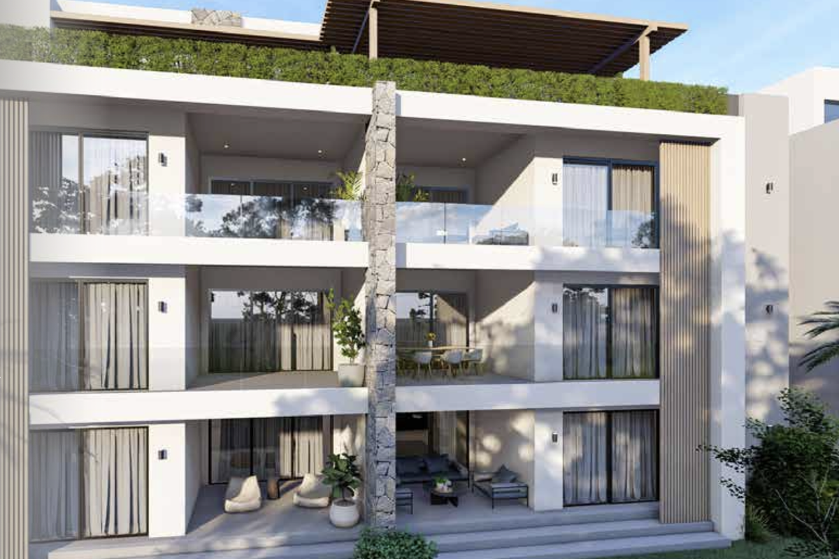 Modern apartment building exterior featuring stacked balconies with glass railings, stone feature wall, and a rooftop pergola structure.