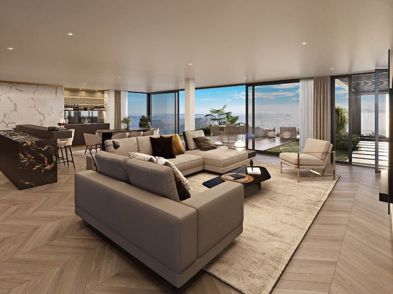 Spacious open-plan living area featuring herringbone timber flooring, a modern marble kitchen island, and seamless indoor-outdoor flow through large sliding glass doors.