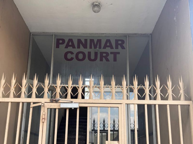 Entrance to Panmar Court featuring a metal security gate and glass door access.