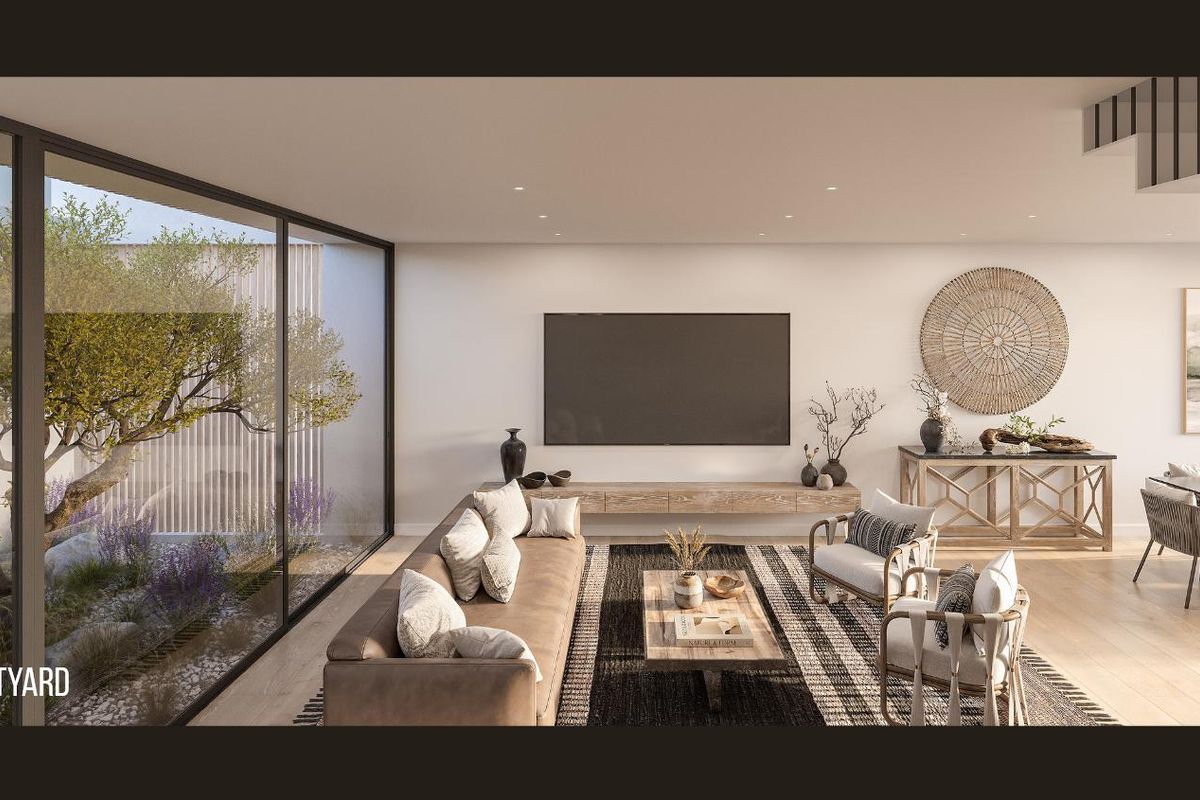 Modern open-plan living area featuring floor-to-ceiling glass walls overlooking a private courtyard, recessed lighting, and high-quality timber flooring.