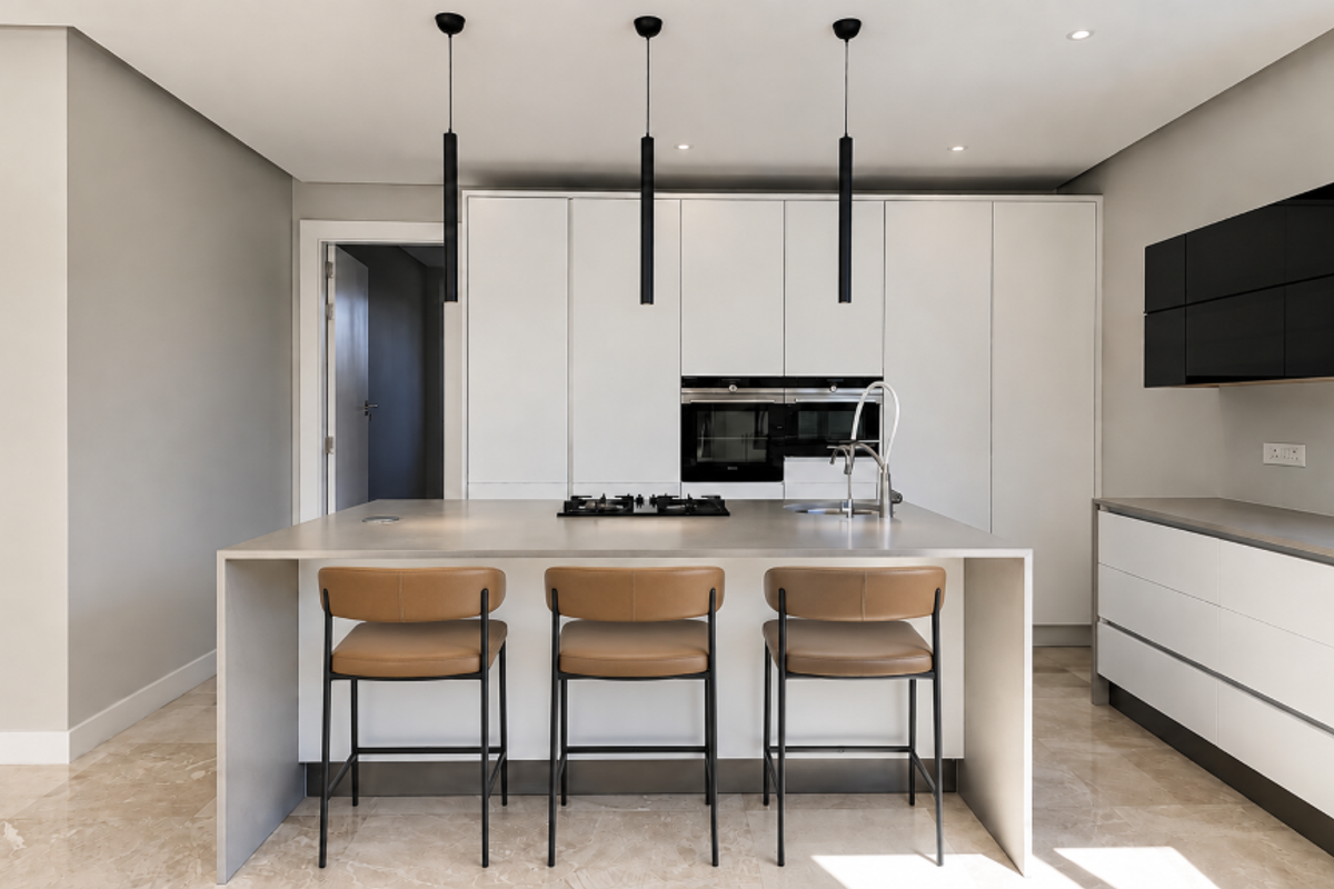 Modern kitchen featuring a central island with a gas cooktop, integrated sink, sleek white cabinetry, built-in ovens, and contemporary pendant lighting.