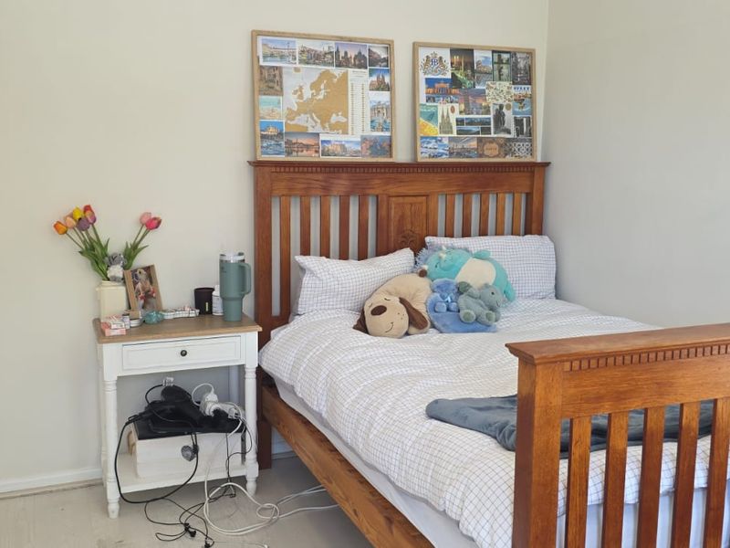 A bedroom featuring neutral wall finishes and direct access to an en-suite bathroom.