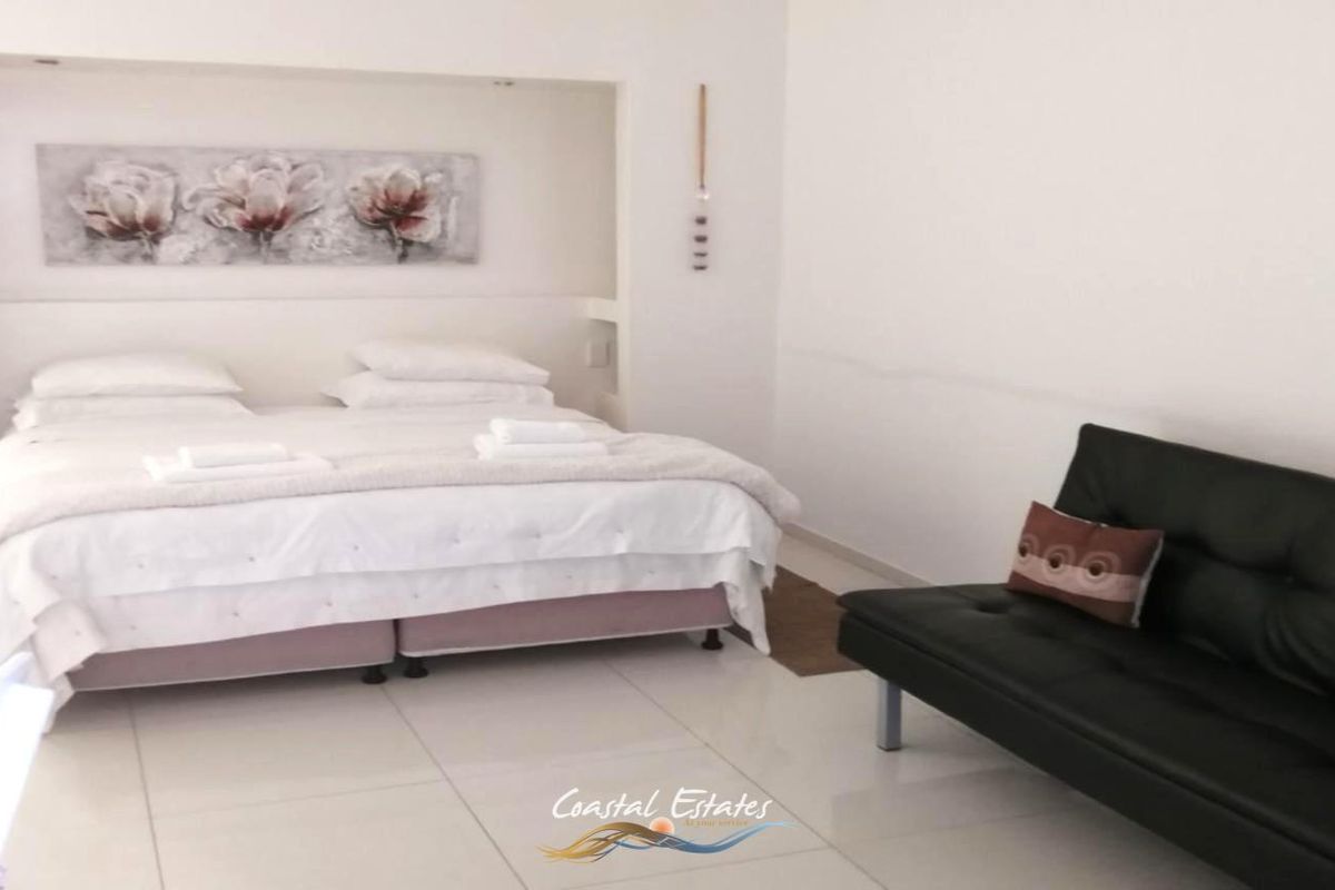 A bedroom featuring a recessed bed alcove and tiled flooring, presented in a simple, functional layout.