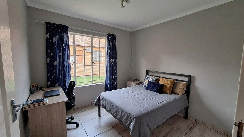 The 2nd bedroom will fit a queen size bed. The furniture in this photo has been digitally staged using AI. 