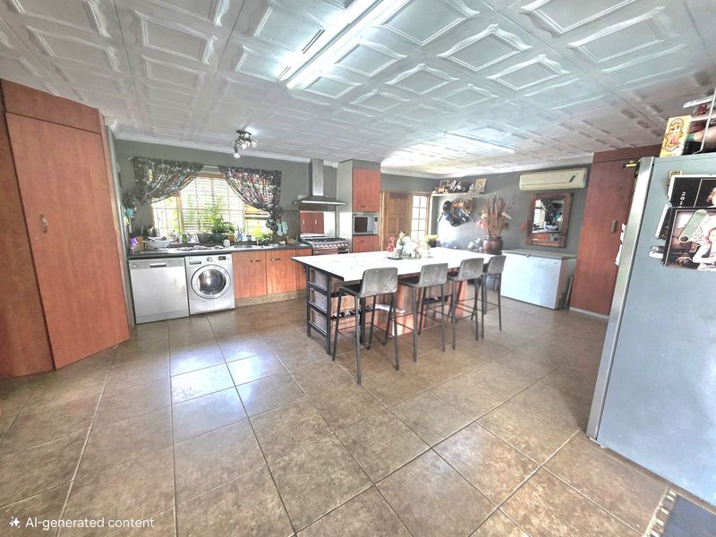 Spacious kitchen featuring a central island, tiled flooring, coffered ceiling, and built-in cabinetry with integrated appliances.