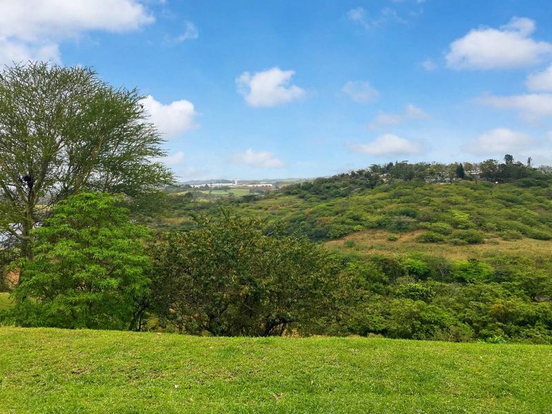 A scenic view of the surrounding green hills and natural landscape.