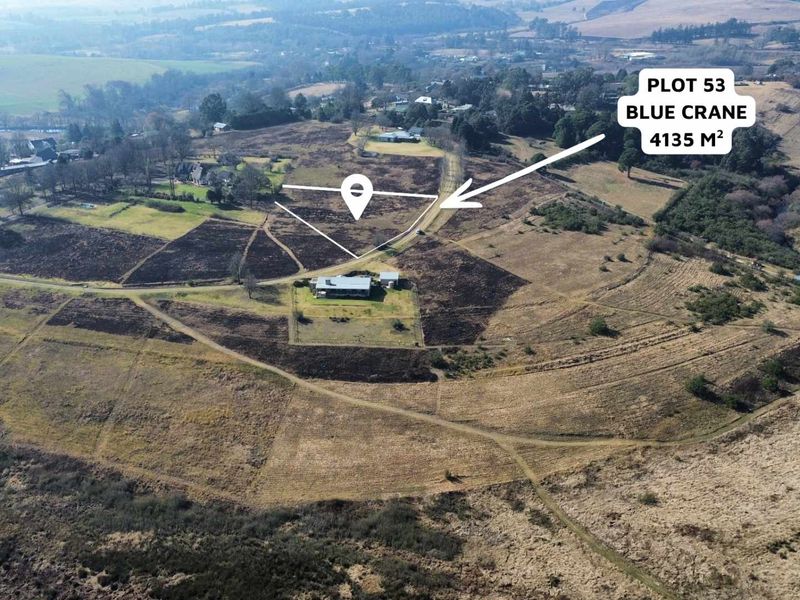 An aerial view of a 4135 square meter residential plot in a rural estate setting, showing surrounding landscape and access roads.