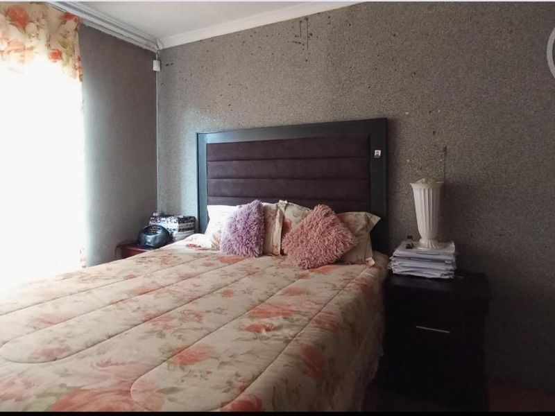 A bedroom featuring a textured wall finish, offering a blank canvas for potential cosmetic updates and interior design improvements.