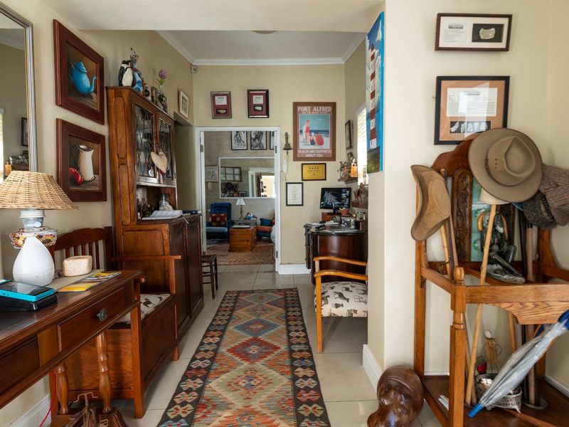 A welcoming hallway featuring tiled flooring and neutral wall finishes, providing a clear transition between the main entrance and the adjoining living spaces.