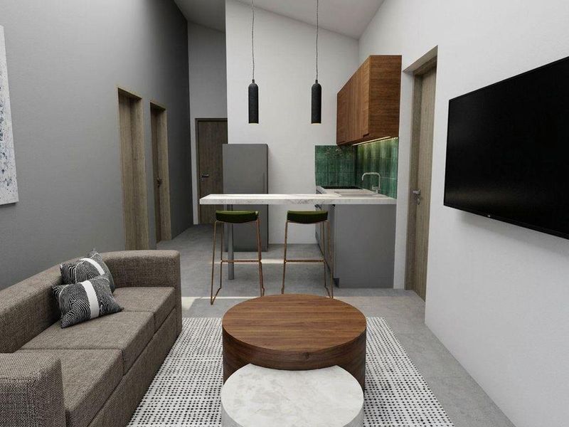 Modern open-plan living area featuring a compact kitchen with stone countertops, tiled splashback, and high vaulted ceilings.