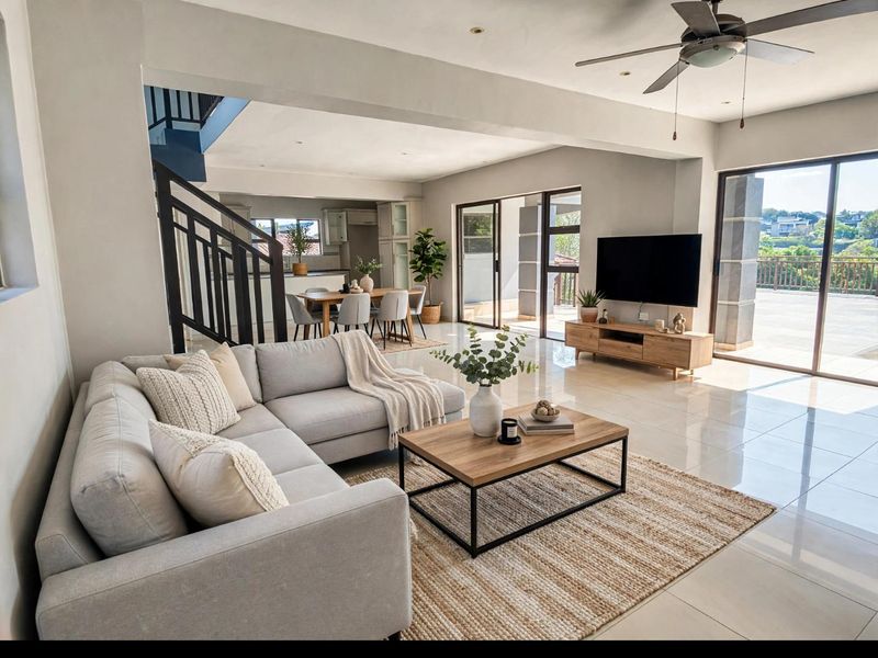 Spacious open-plan living and dining area featuring modern porcelain tile flooring, recessed lighting, a ceiling fan, and large sliding doors leading to an outdoor balcony.