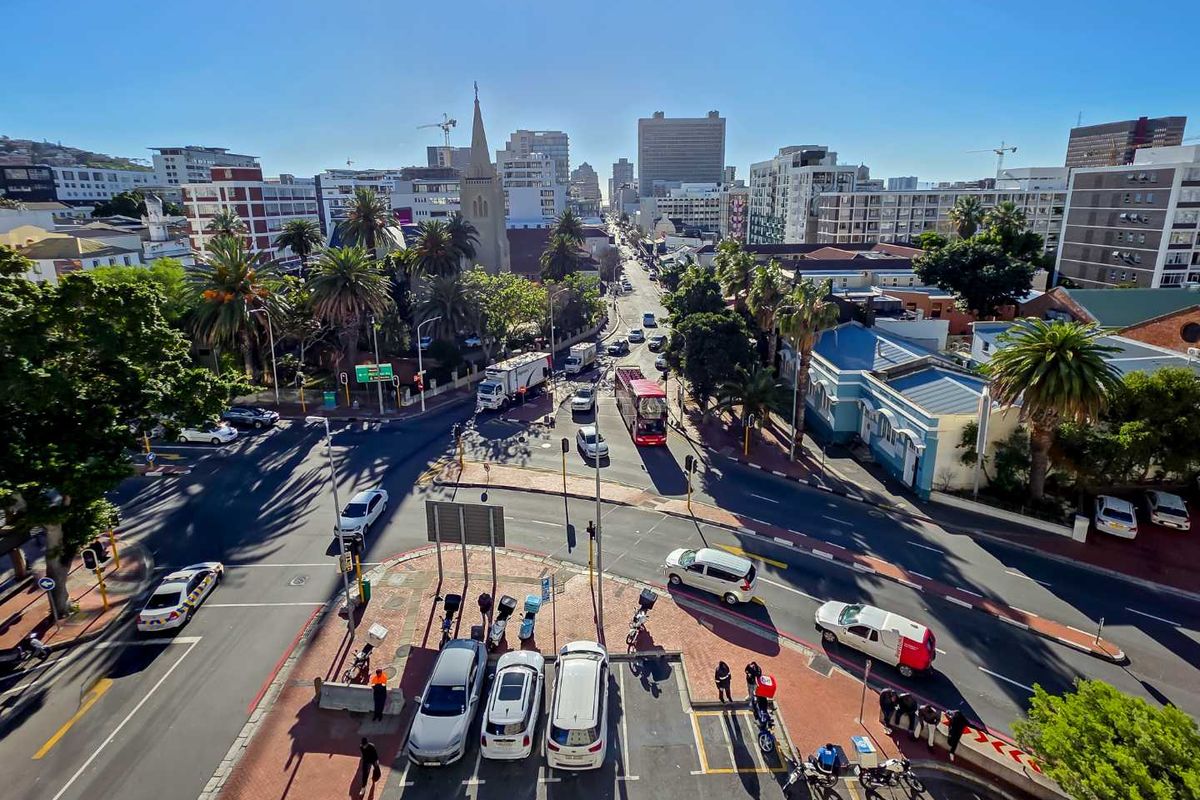 An elevated aerial view overlooking a busy urban intersection and surrounding city buildings.