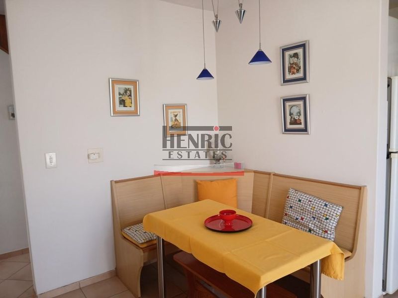 A cozy dining nook featuring tiled flooring and pendant lighting, suitable for casual meals.