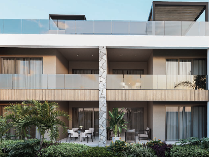 Modern penthouse exterior featuring clean architectural lines, glass balustrades, stone accents, and timber detailing with spacious covered balconies and a rooftop terrace.