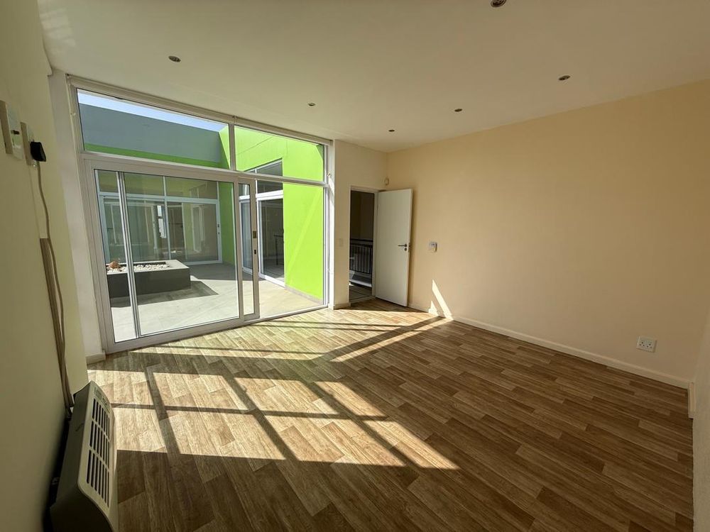 Main en-suite bedroom with a walk-in closet and connecting balconies