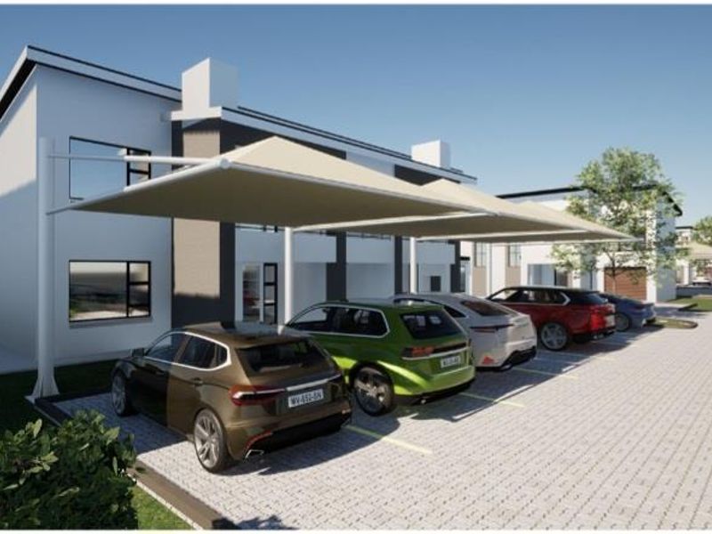 Modern residential exterior featuring paved parking bays with shade cloth structures and contemporary building facade.