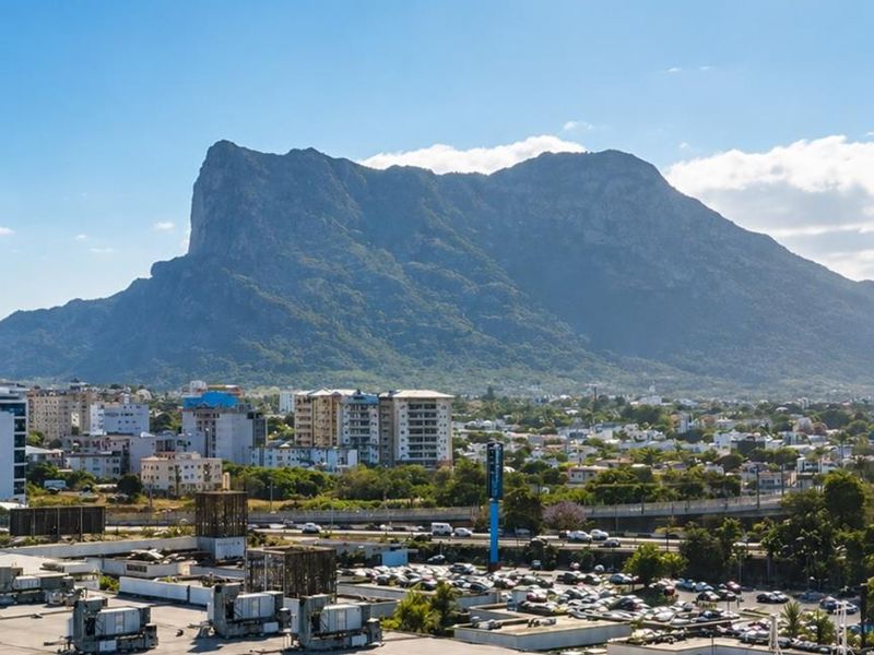 Elevated panoramic view overlooking the surrounding urban landscape and prominent mountain range.
