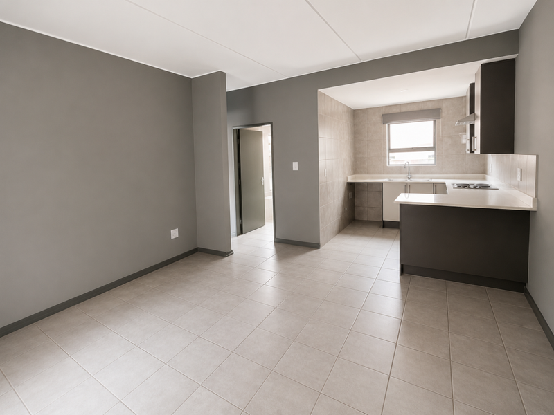 An open-plan living and kitchen area featuring neutral grey walls, tiled flooring, and modern built-in cabinetry with stone countertops.