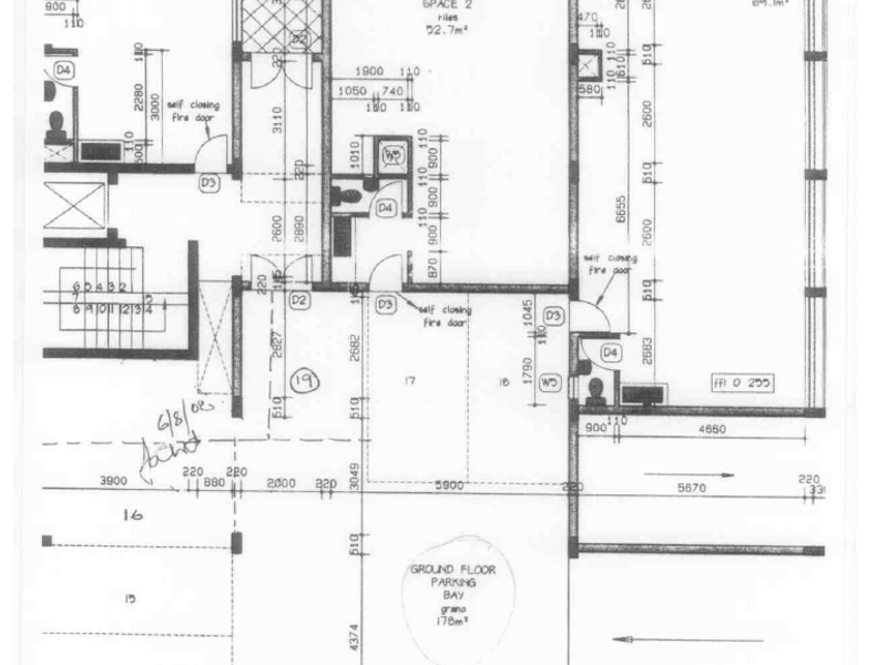 Architectural ground floor plan showing three rentable spaces and a designated parking bay area.