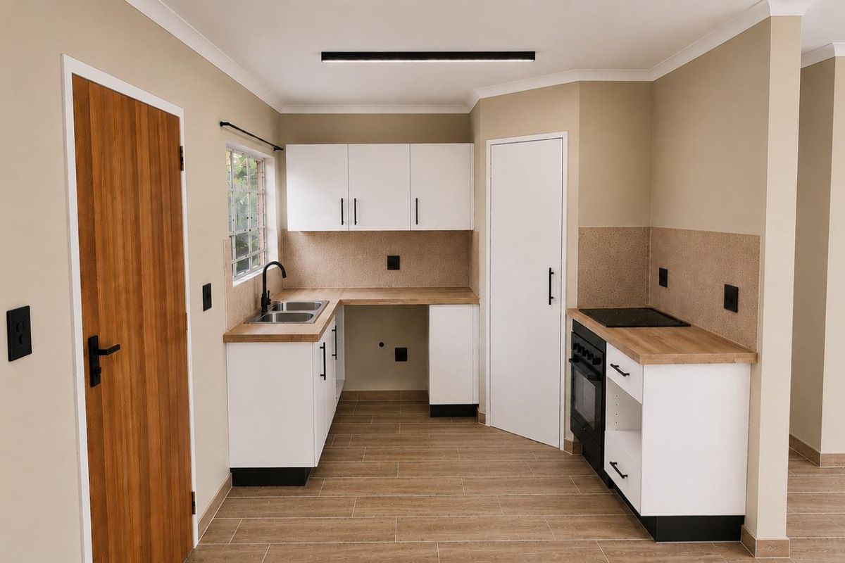 A modern, clean kitchen featuring white cabinetry, wood-look laminate countertops, a built-in oven with hob, and tiled flooring in a neutral color palette.
