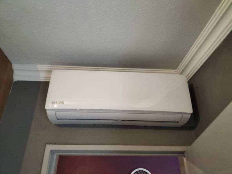 A wall-mounted Goldair air conditioning unit installed in an interior space.