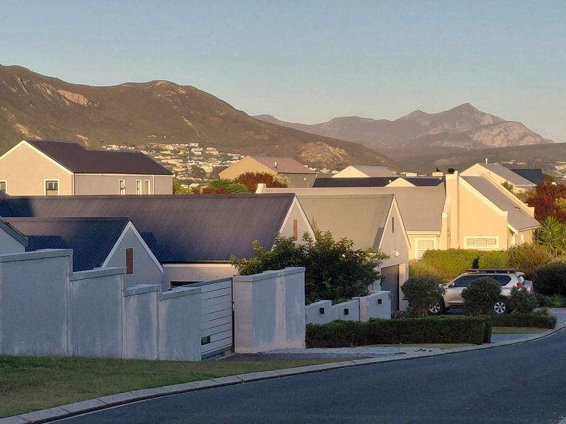 A scenic view of the surrounding residential neighborhood with prominent mountain vistas in the background.