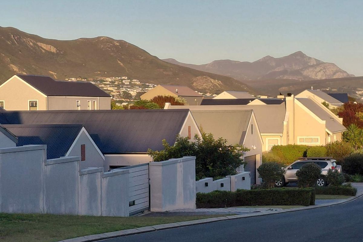 A scenic view of the surrounding residential neighborhood with prominent mountain vistas in the background.
