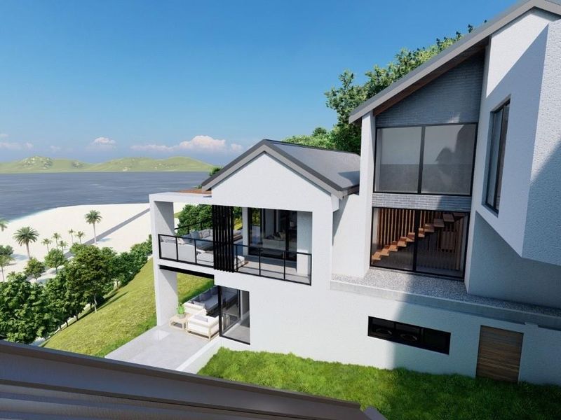 A modern multi-level coastal residence featuring a balcony, patio, and large windows with scenic ocean views.