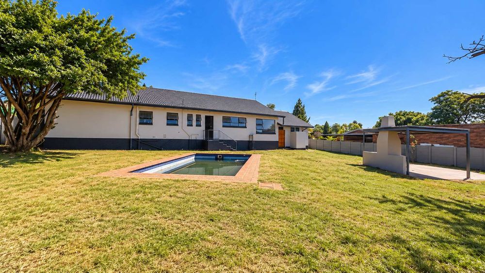Back garden with pool and entertainment area