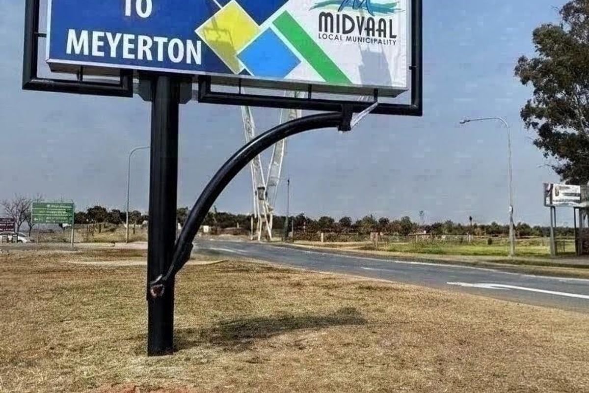 A roadside welcome sign for the Meyerton area, featuring a large municipal billboard structure situated along a paved road.