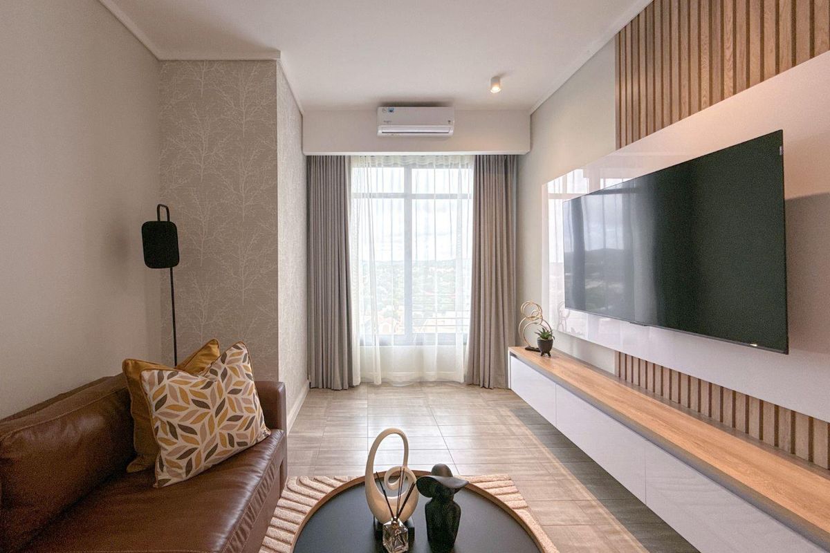 Modern living room featuring a sleek wall-mounted media console, timber slat feature wall, and split-system air conditioning unit.