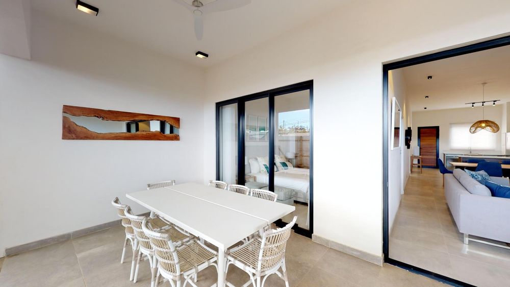 Patio with seating areas. Sliding doors leading to both the lounge and one of the bedrooms