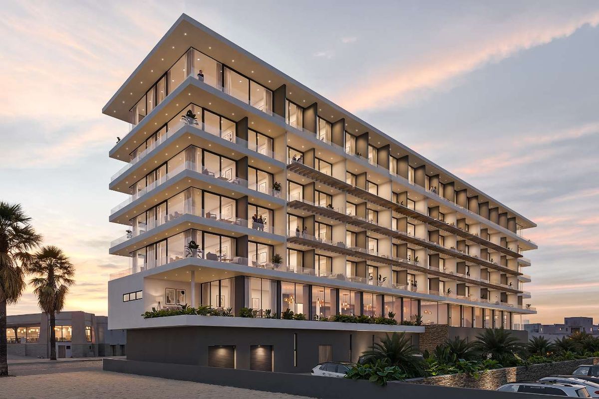 A modern multi-story apartment building featuring extensive glass facades, private balconies, and contemporary architectural design.