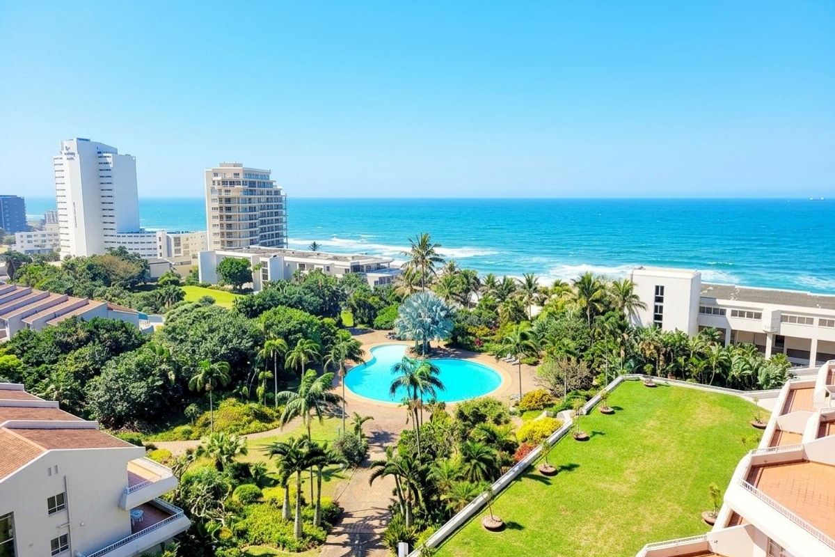 Elevated panoramic view overlooking the complex swimming pool, lush landscaped gardens, and the ocean coastline.