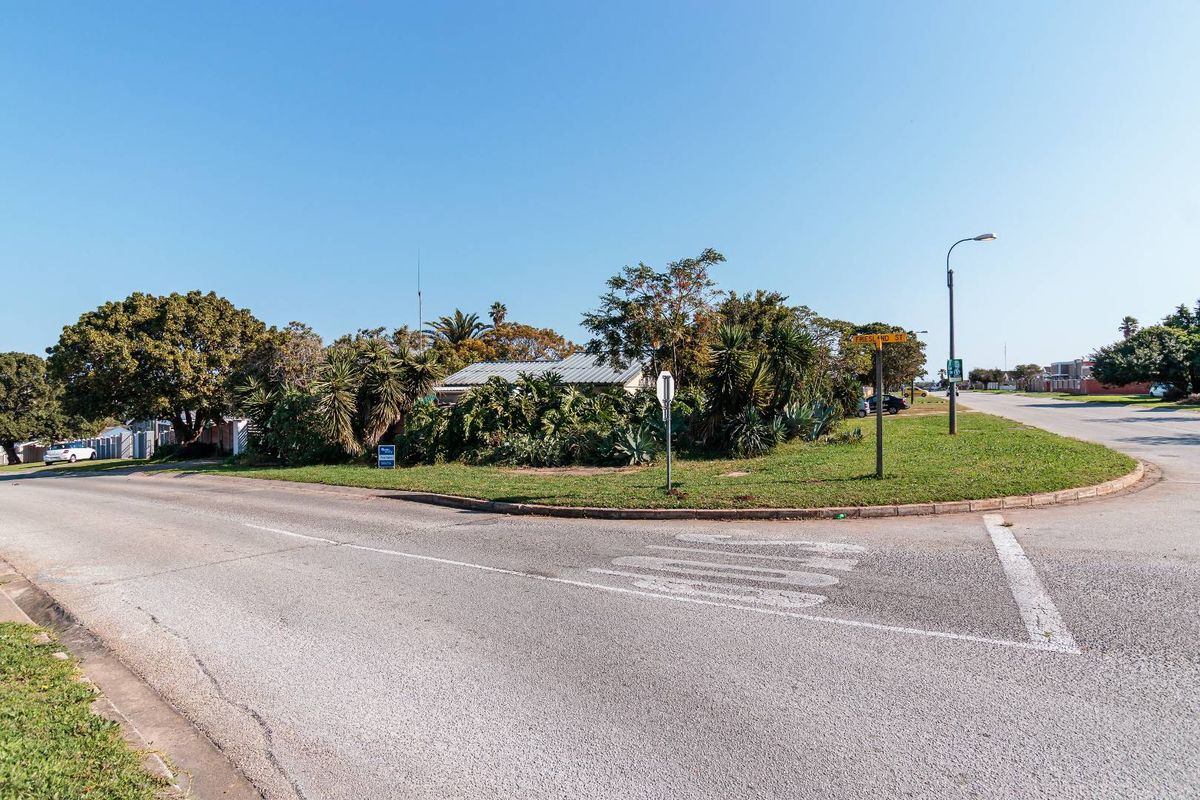 A street view showing the corner intersection and approach to the property, featuring established landscaping and public infrastructure.