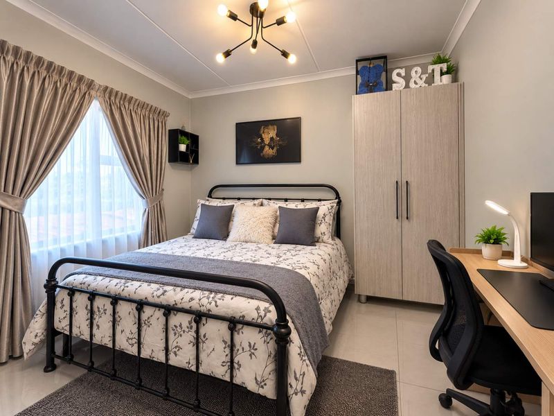 A well-maintained bedroom featuring tiled flooring, a built-in wardrobe, and a modern ceiling light fixture, offering a clean and functional living space.