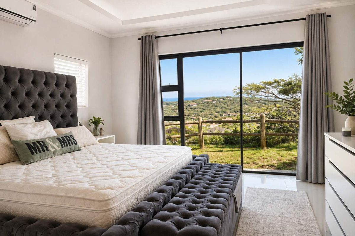 Spacious bedroom featuring a modern recessed ceiling, tiled flooring, and large sliding glass doors that open to a scenic landscape view.