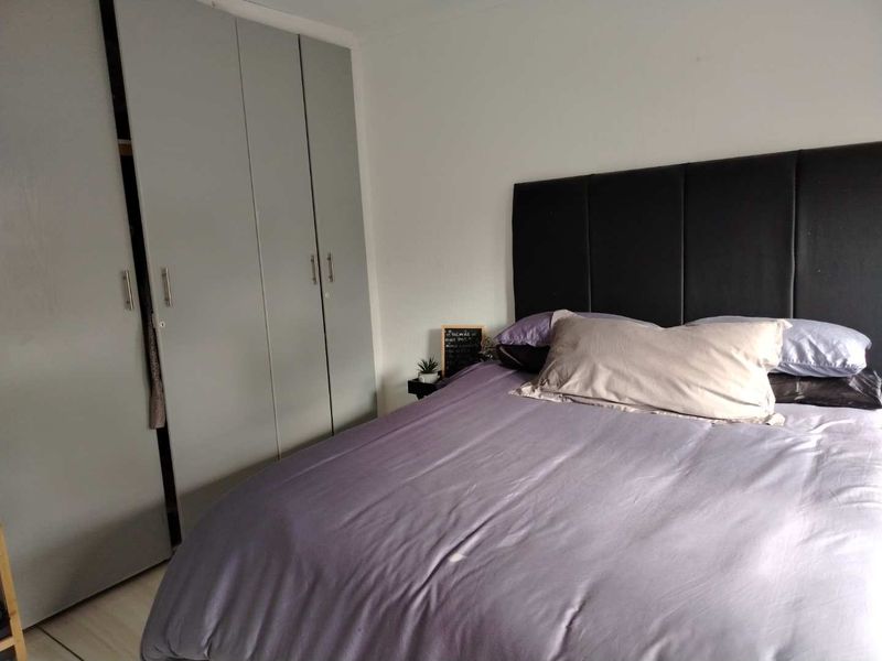 A bedroom featuring neutral walls and functional built-in cupboards providing ample storage space.
