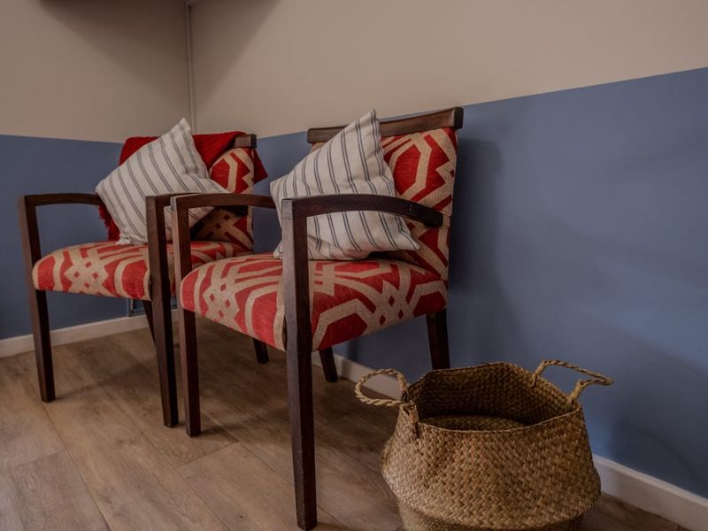 A close-up view of a corner featuring two-tone painted walls and wood-look flooring.
