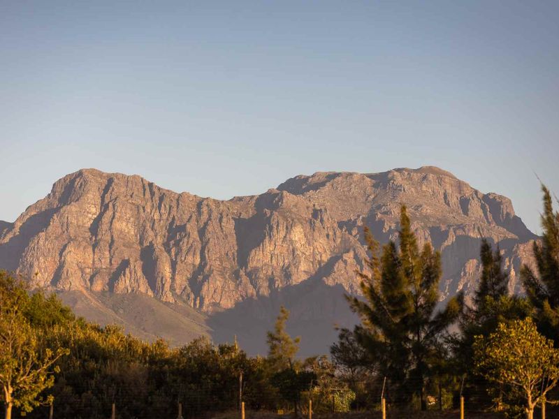 A scenic view of a prominent mountain range, showcasing the natural landscape and surrounding vegetation.