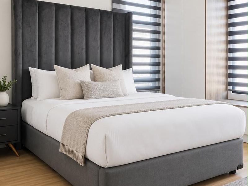 A well-appointed bedroom featuring modern laminate flooring, built-in cupboards, and contemporary roller blinds, creating a clean and comfortable living space.