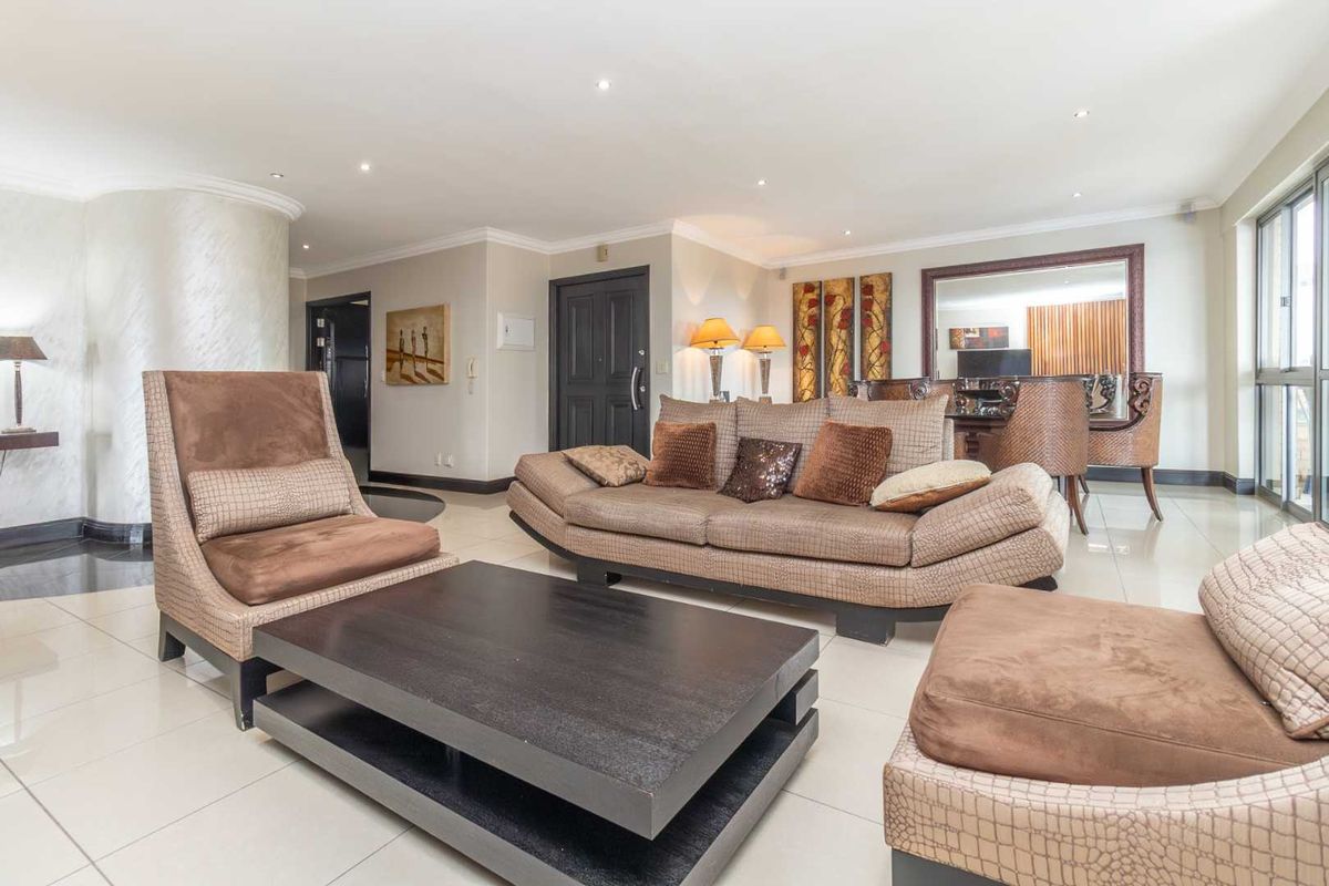 Spacious living area featuring polished tiled flooring, recessed downlighting, and large sliding glass doors providing natural light.