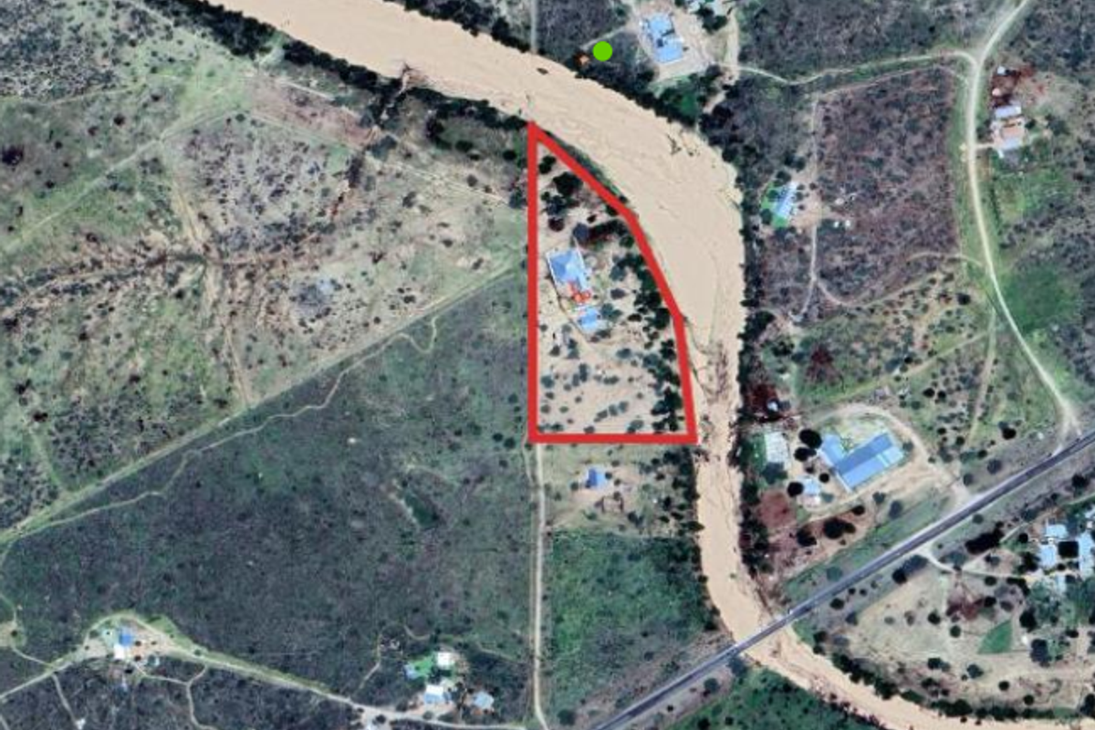 Aerial satellite view of the small holding property, highlighting the plot boundaries and its proximity to the adjacent river.