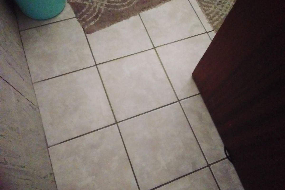 A close-up view of tiled flooring in an unidentified interior space.