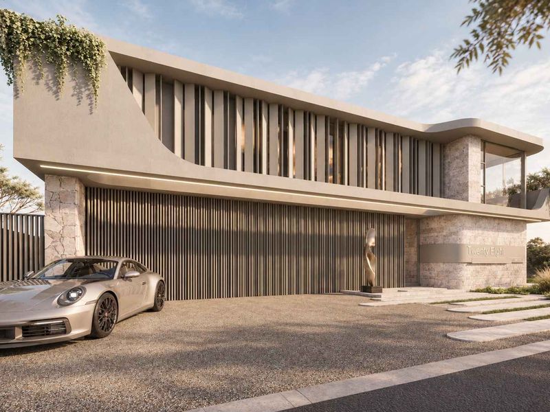 Modern architectural front elevation featuring stone cladding, vertical louvers, and a sleek integrated garage door design.