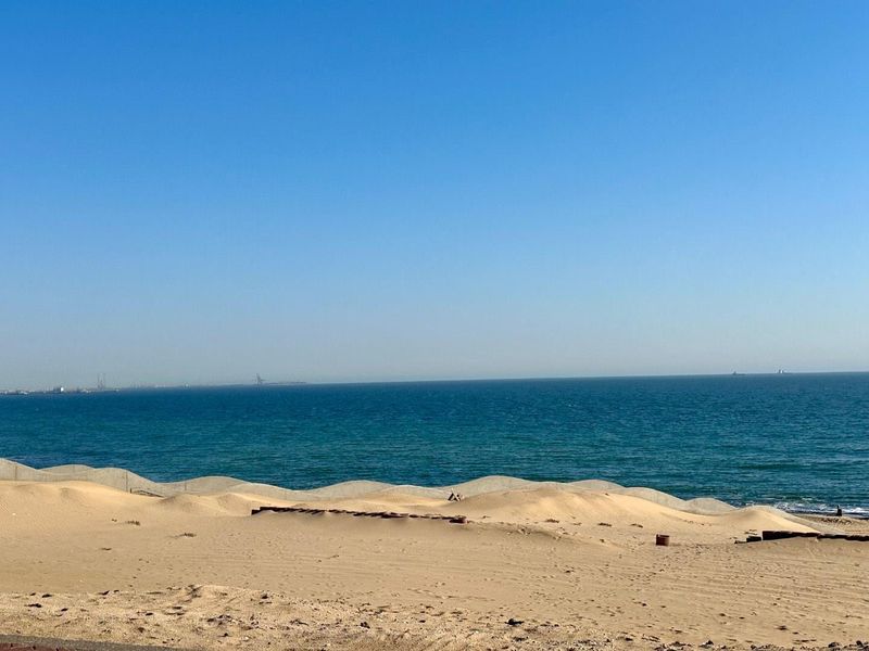 A scenic view of the ocean and sandy beach coastline.