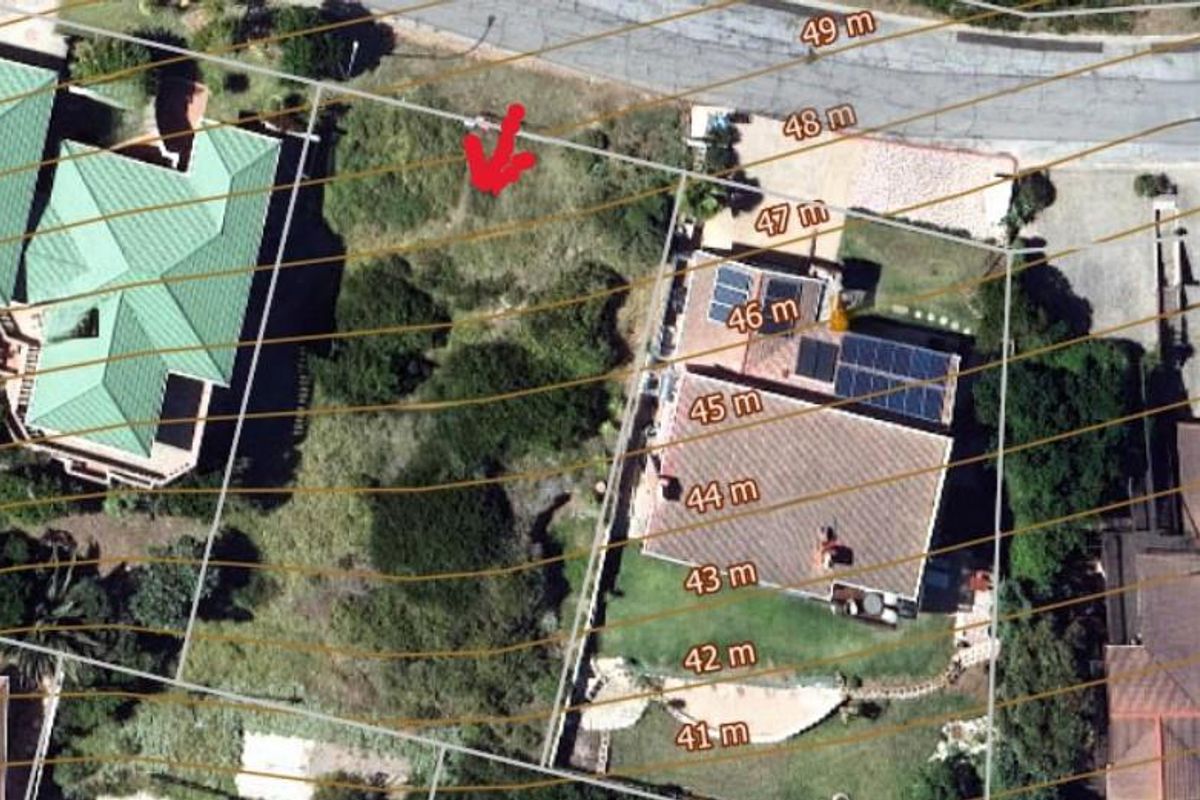 Aerial view of a vacant residential plot featuring topographical contour lines and surrounding established properties.