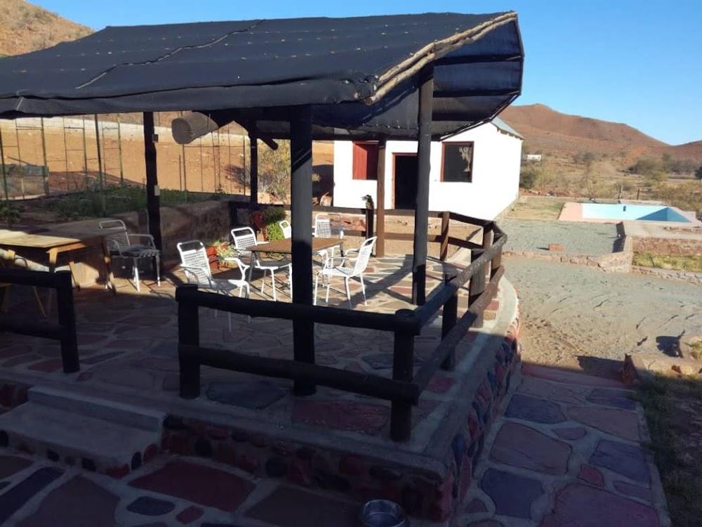 Covered Lapa with seating area and a pool in the background