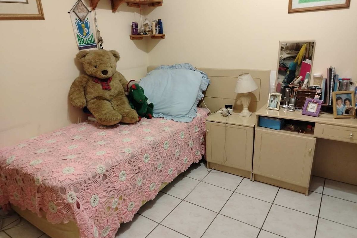 A functional bedroom featuring tiled flooring and built-in cabinetry, providing a practical and comfortable living space.