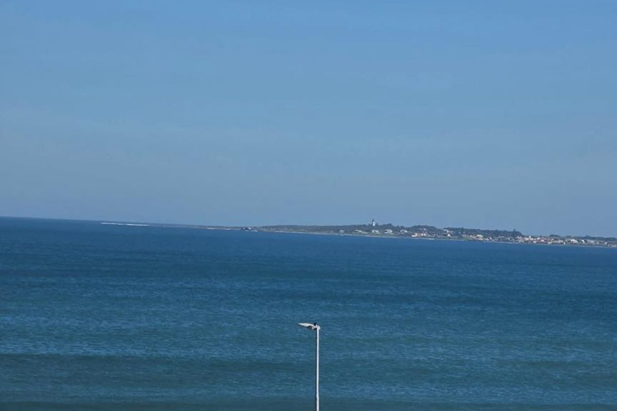 A clear, elevated view of the ocean and coastline, showcasing the property's scenic outlook.